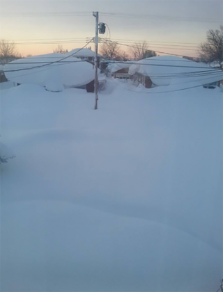 Illustration for article titled Holy mother of God, check out the giant snow wall swallowing Buffalo